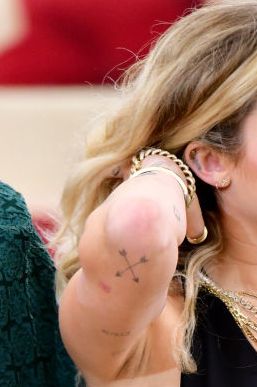 Crossed Arrows on her Right Elbow. Miley Cyrus Tattoos Meaning